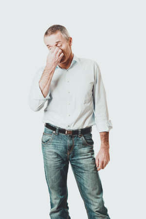 Man holding his nose because of sinus painの写真素材