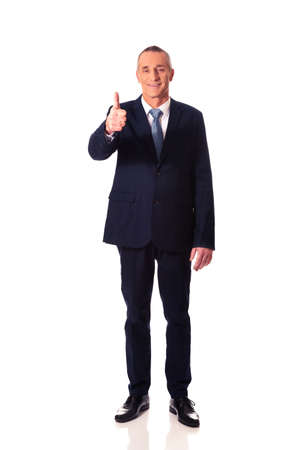 Mature businessman gesturing ok signの写真素材