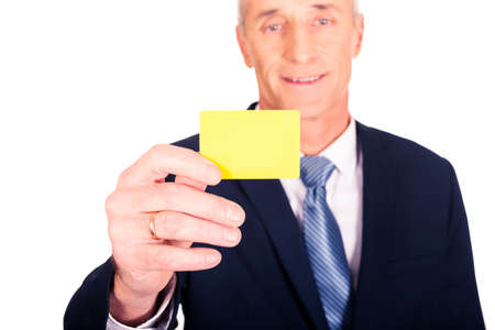 Businessman showing a yellow identity name cardの写真素材