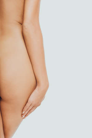 Back view of naked womans buttocksの写真素材