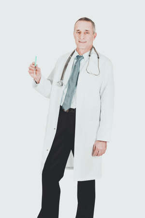 Male doctor holding a syringeの写真素材