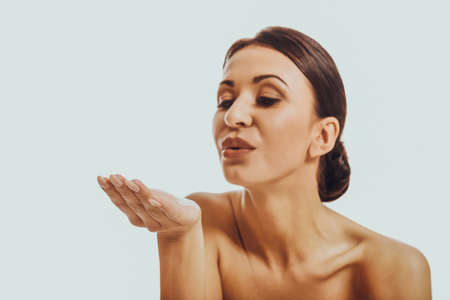 Beautiful woman blowing a kissの写真素材