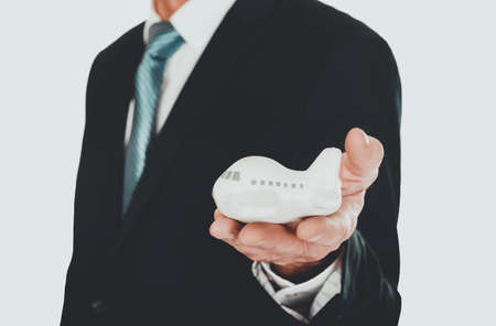 Close up on male hand holding small airplaneの写真素材