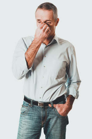 Man holding his nose because of sinus painの写真素材