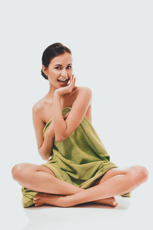 Front view woman sitting cross-leggedの写真素材