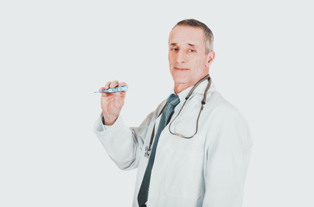 Mature male doctor holding a thermometer