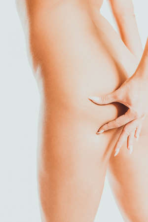 Spa woman checking fat on bumの写真素材