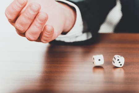 Businessman's hand with two dices.の写真素材
