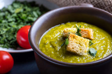 Green squash soup with parsley and croutonsの写真素材