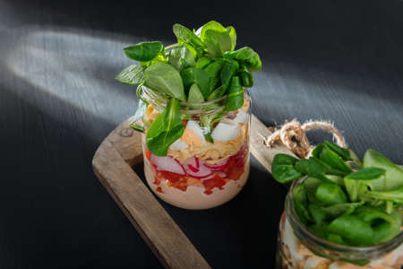 Two glass jars with fresh salad.の写真素材