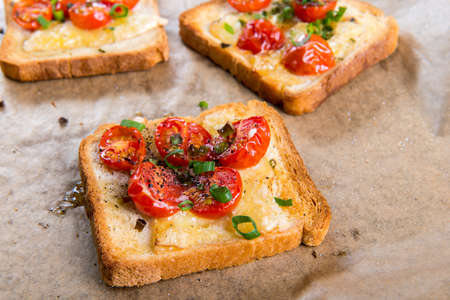 Grilled toast with camembert and cherry tomatoes.の写真素材