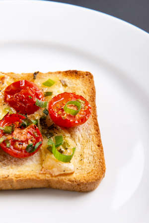 Grilled toast with camembert and cherry tomatoes.の写真素材