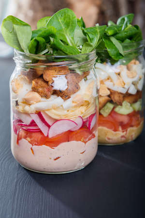 Two glass jars with fresh salad.の写真素材