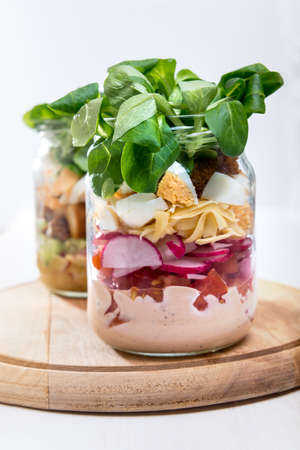 Two glass jars with fresh salad.の写真素材