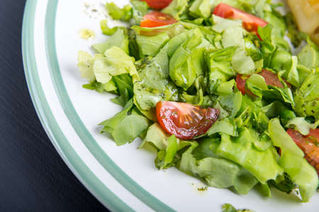 Fresh salad- lettuce with cherry tomatoes.の写真素材