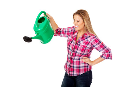 Happy woman holding a watering canの写真素材