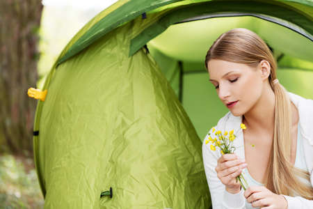 Young woman resting in a tent on the natureの写真素材