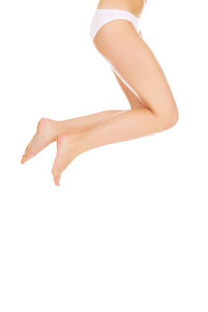 Legs and bottom of jumping woman in white panties.の写真素材