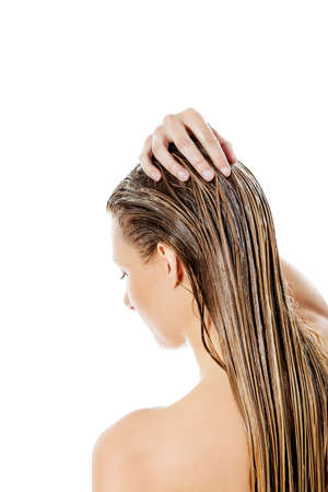 Photo of woman applying hair egg conditionerの写真素材