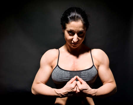 Muscular bodybuilder woman showing her muscles.の写真素材