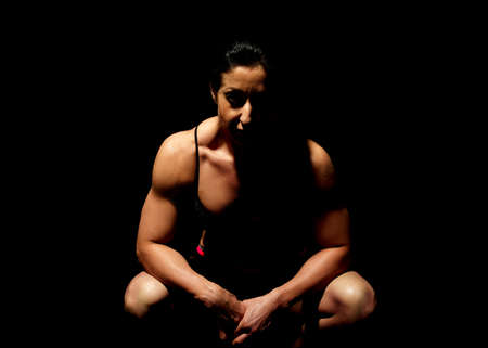 Muscular bodybuilder woman showing her muscles.の写真素材