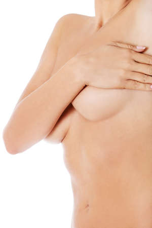 Topless woman covers her breasts with hands. Isolated on white.の写真素材
