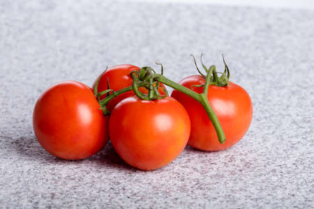 Four red fresh juicy tomatoes.の写真素材