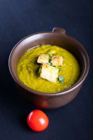 Green squash soup with parsley and croutons.の写真素材