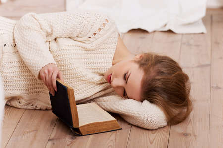 Beautiful caucasian woman lying on the floor.の写真素材