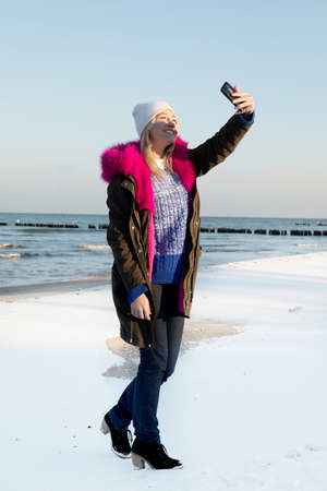 Beautiful young teen girl having fun and making selfie.の写真素材