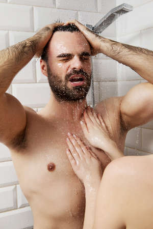 Young couple taking shower.の写真素材