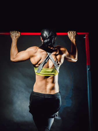 Bodybuilder women excercising on rodの写真素材