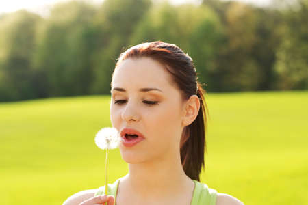 Young woman posing with flowers . Outdoor shot.の写真素材