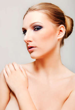 Attractive blonde topless woman with dark eye make upの写真素材