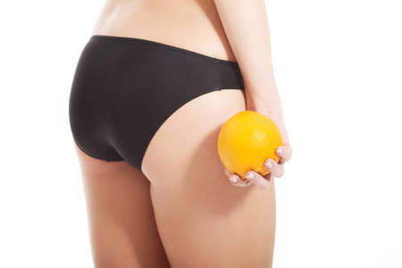 Beautiful slim and supple female buttocks with orange.の写真素材