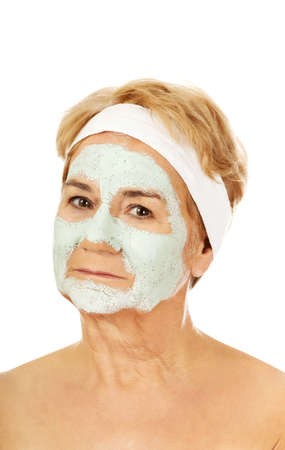 Relaxed elderly woman in facial maskの写真素材