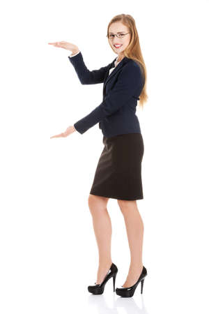 Beautiful caucasian business woman is having empty space between her hands.の写真素材