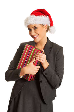 Woman weating Santa hat and holding a presentの写真素材