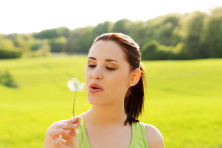Young woman posing with flowers . Outdoor shot.の写真素材