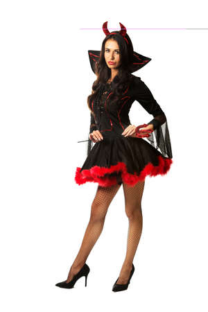 Woman wearing devil clothes holding tridentの写真素材