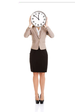 Beautiful caucasian business woman with clock on face.の写真素材