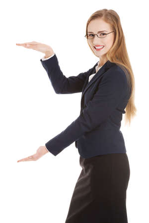 Beautiful caucasian business woman is having empty space between her hands.の写真素材