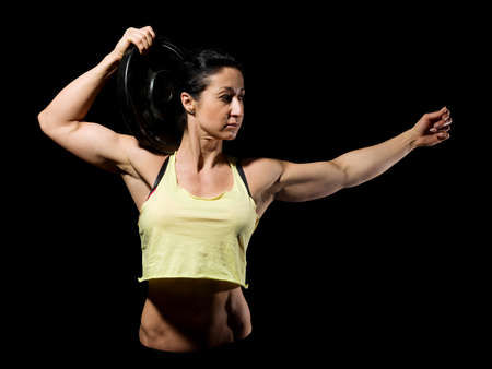 Muscular bodybuilder woman showing her muscles.の写真素材