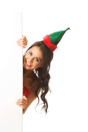 Woman wearing elf clothes hiding behind white banner, looking at the cameraの写真素材