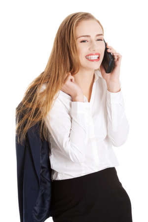 Attractive sensual caucasian business woman is talking through phone.の写真素材