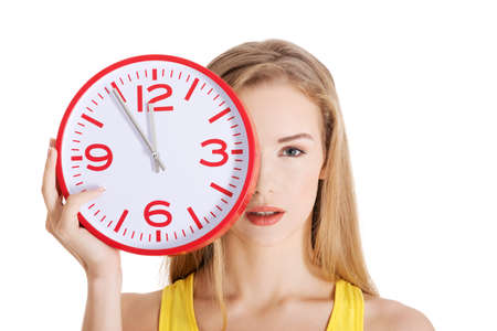 Beautiful caucasian casual woman holding red clock.の写真素材