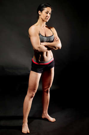 Muscular bodybuilder woman showing her muscles.の写真素材