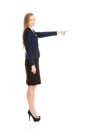 Beautiful business woman pointing on copy space.の写真素材