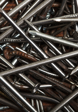 Pile of metal nails on wooden backgroundの写真素材