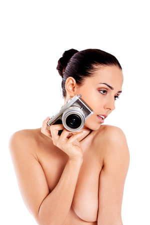 Nude beautiful woman with photo camera.の写真素材